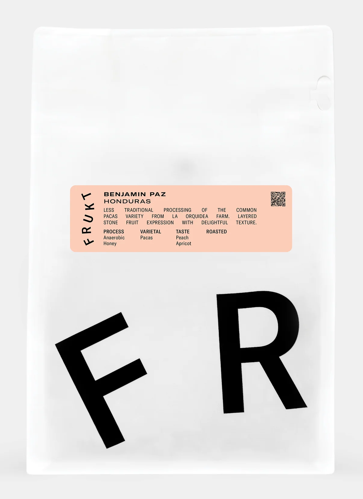 A white Frukt coffee bag with oversized black letters and a small peach sticker for Benjamin Paz's coffee from Honduras.